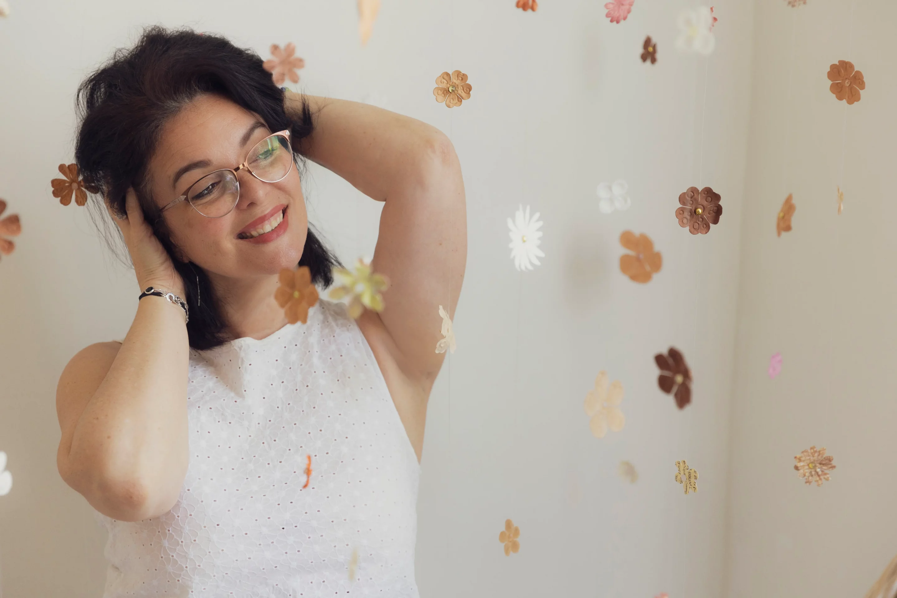 sandra-alvoet photo de sandra alvoet, relevant ses cheveux, entourée de fleurs suspendues
