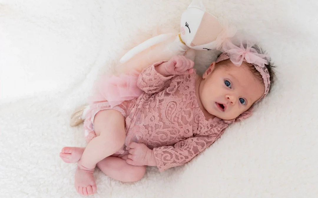 photo de bébé habillée en rose sur fond blanc