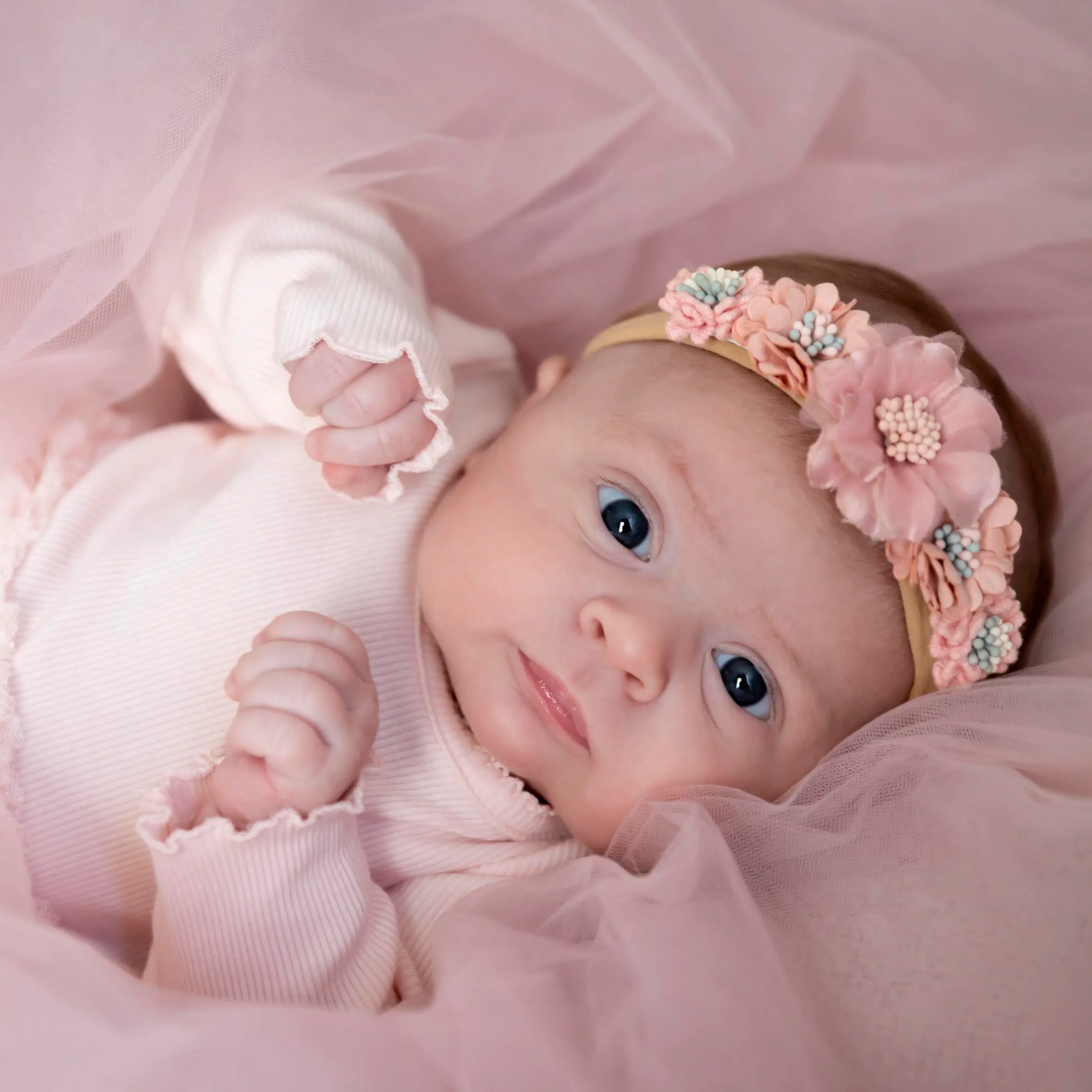 photo de bébé, entourée d'un voile rose